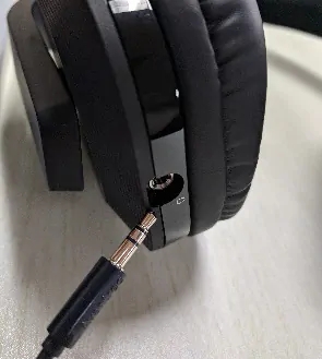 3.5mm AUX cable being connected to the HT280 headphone jack