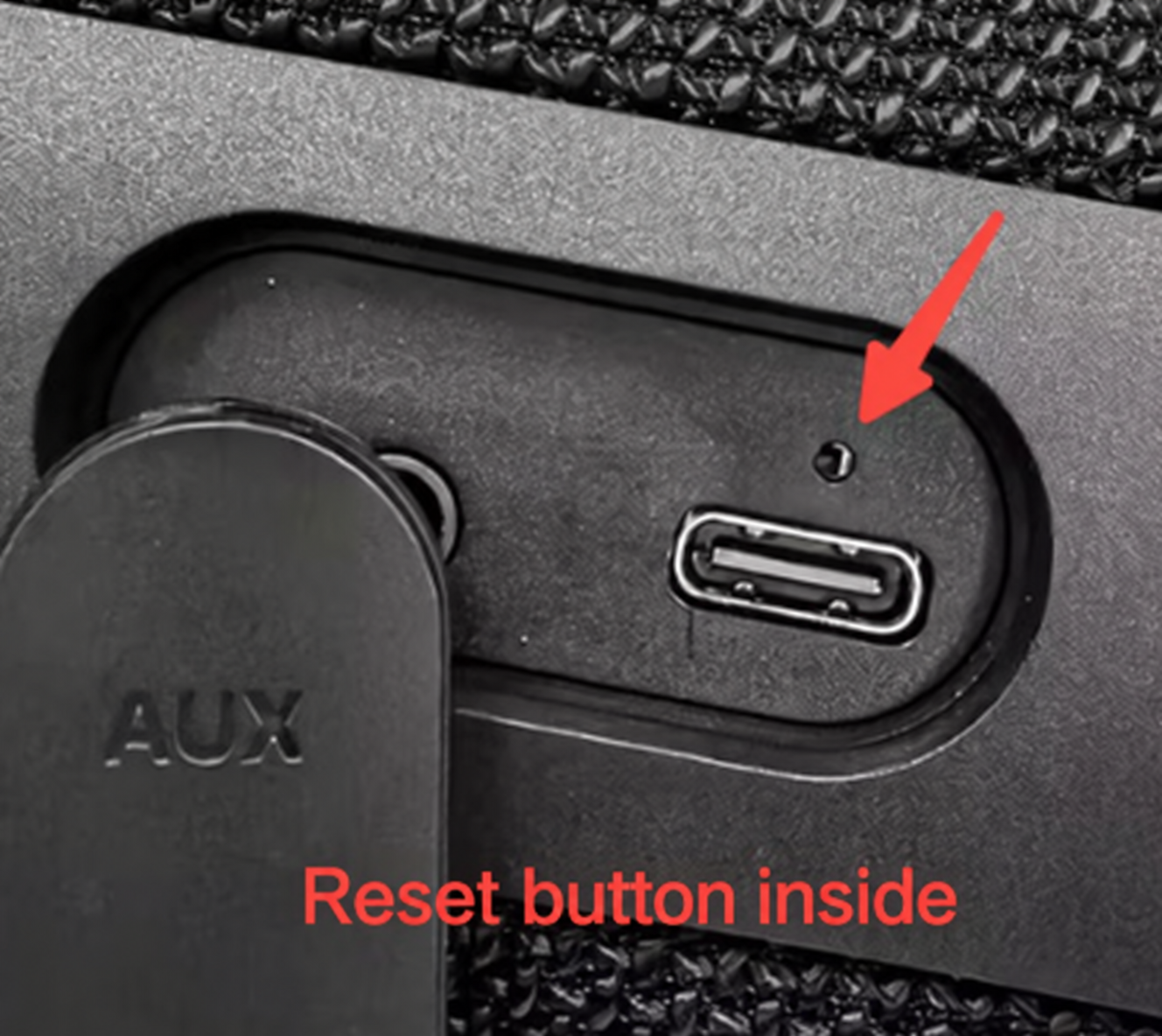 Reset button inside the pinhole above the USB-C charging port