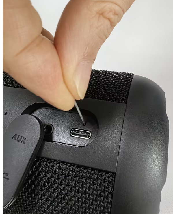 Gently press the button inside the pinhole with a thin pin